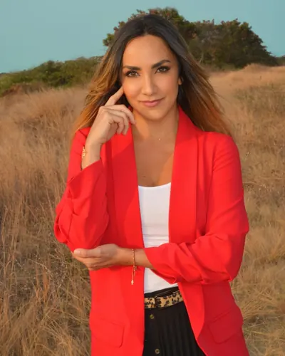Paola Carlton in a red blazer outdoors